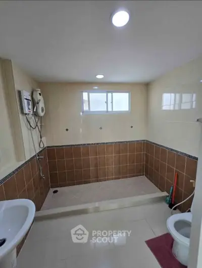 Spacious bathroom with modern fixtures and large walk-in shower area.