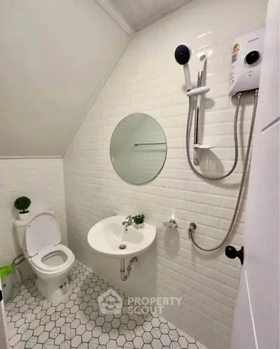 Compact bathroom with modern fixtures and white tile design