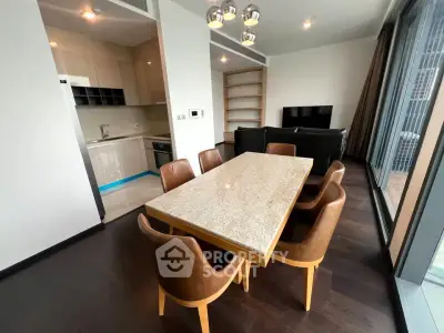 Modern open-plan living and dining area with sleek kitchen and stylish furniture.