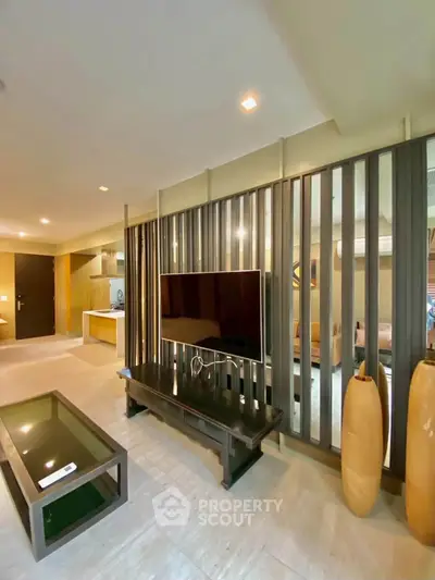 Modern living room with stylish partition and sleek furniture in a contemporary apartment.