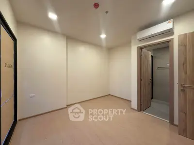 Minimalist bedroom with ensuite bathroom and air conditioning