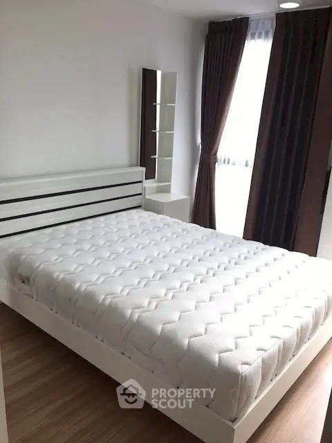 Modern bedroom with stylish bed and large window for natural light