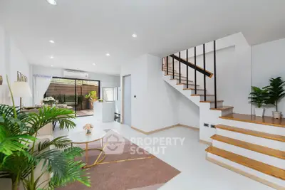 Modern living room with staircase and stylish decor