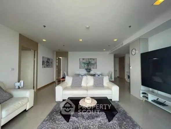 Spacious modern living room with elegant decor and large TV