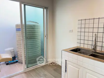 Modern utility area with sleek sink and water tank in bright space