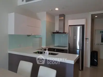 Modern kitchen with sleek design, featuring stainless steel appliances and open layout.