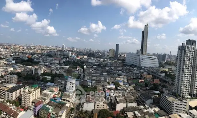 Stunning panoramic cityscape view showcasing urban skyline and high-rise buildings under a clear blue sky.