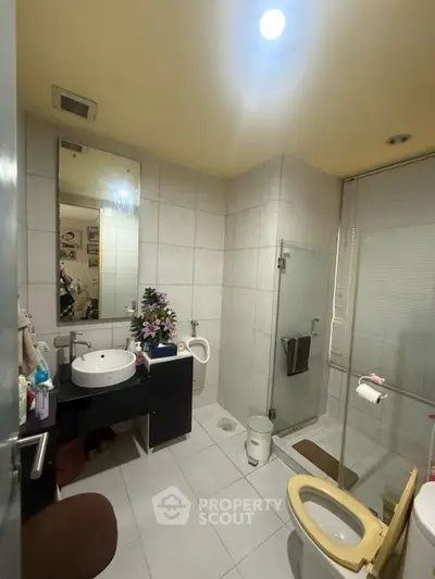 Spacious bathroom with modern fixtures and glass shower enclosure