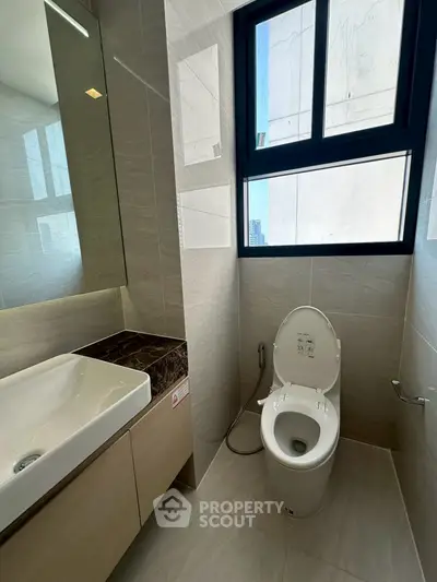 Modern bathroom with sleek design and large window for natural light