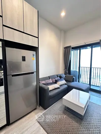 Modern living room with sleek furniture and balcony view in a stylish apartment.