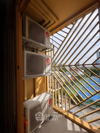 Modern balcony with air conditioning units and city view