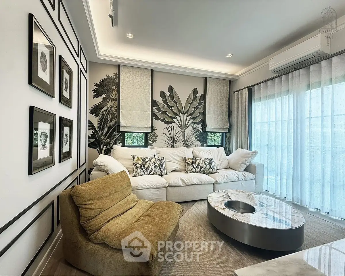 Stylish living room with modern decor, large sofa, and artistic wall design