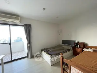 Spacious bedroom with balcony view in modern apartment