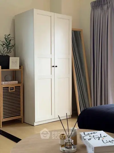 Stylish bedroom with wardrobe, mirror, and elegant decor
