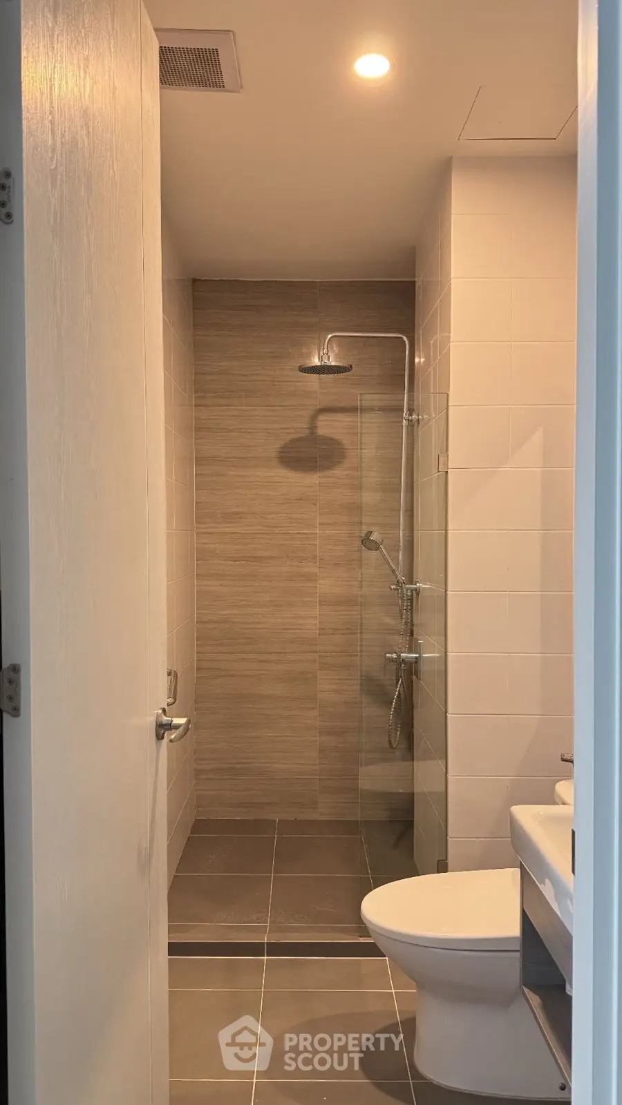 Modern bathroom with sleek shower and contemporary fixtures in a stylish apartment.