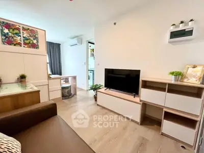 Modern living room with stylish furniture and open layout, featuring a TV and decorative plants.