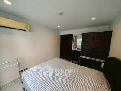 Cozy bedroom with air conditioning and modern furniture