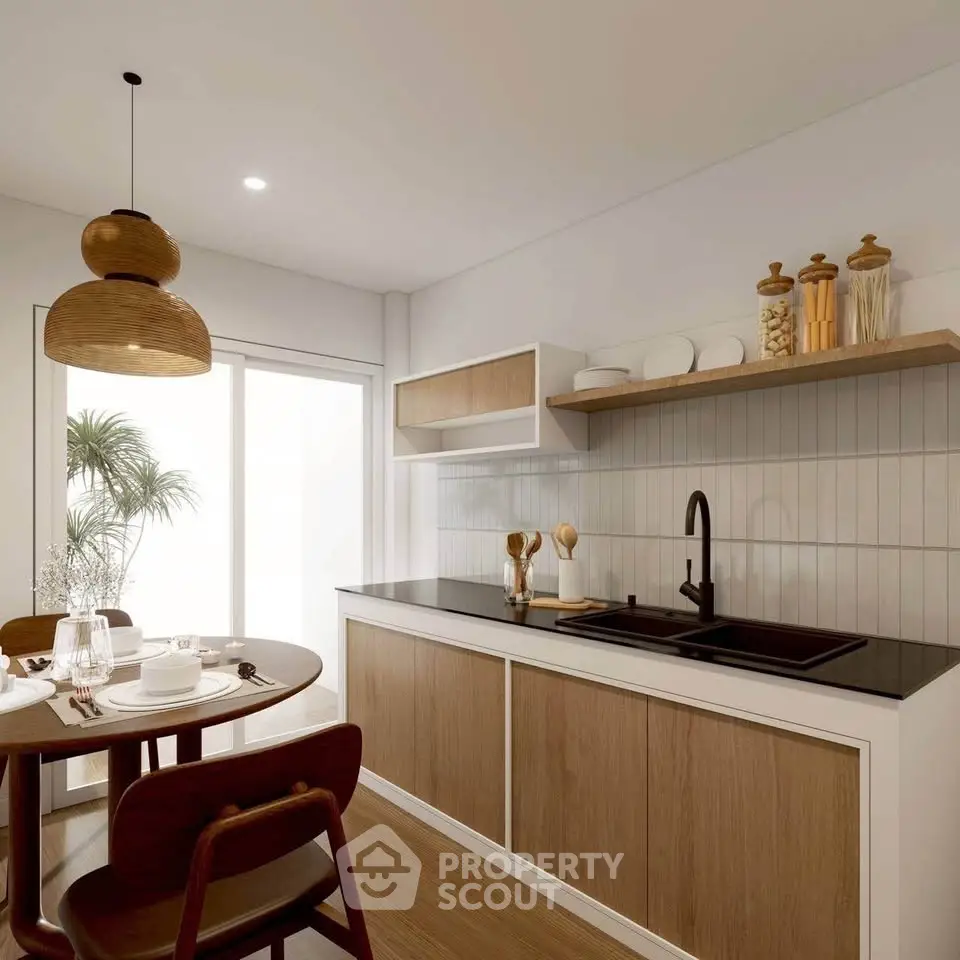 Modern kitchen with sleek black countertop and wooden cabinets, featuring a cozy dining area with elegant tableware.