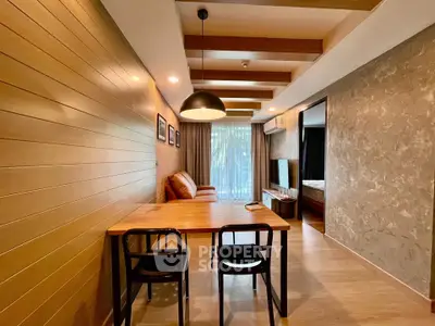 Modern living room with stylish wooden accents and open layout, featuring cozy seating and natural light.