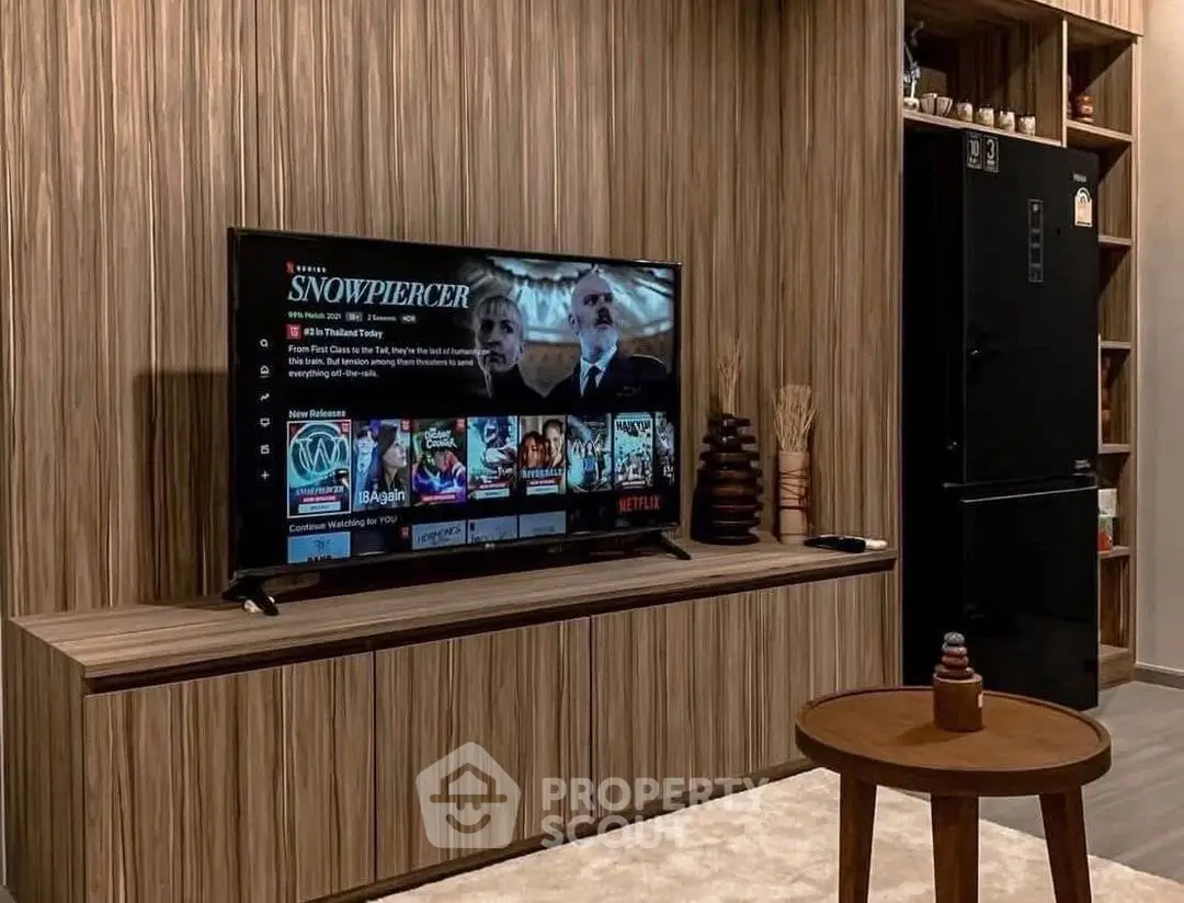 Modern living room with sleek TV setup and stylish wooden decor