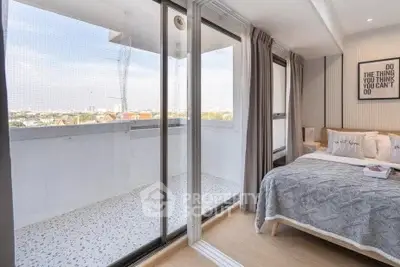 Modern bedroom with balcony access and city view, featuring stylish decor and ample natural light.