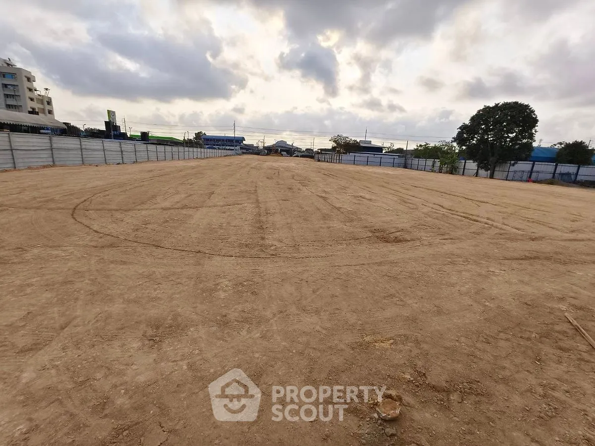 Expansive vacant land ready for development under a cloudy sky, ideal for investment opportunities.