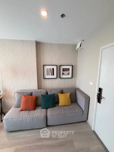 Modern living room with stylish decor and cozy sofa in a contemporary apartment.