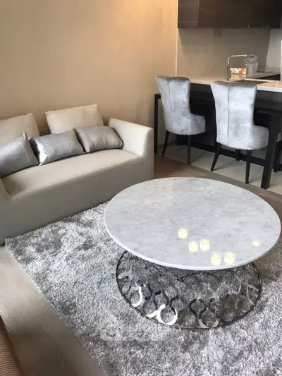 Modern living room with elegant decor and open kitchen layout