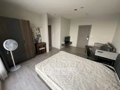 Spacious modern bedroom with minimalist decor and cozy dining area