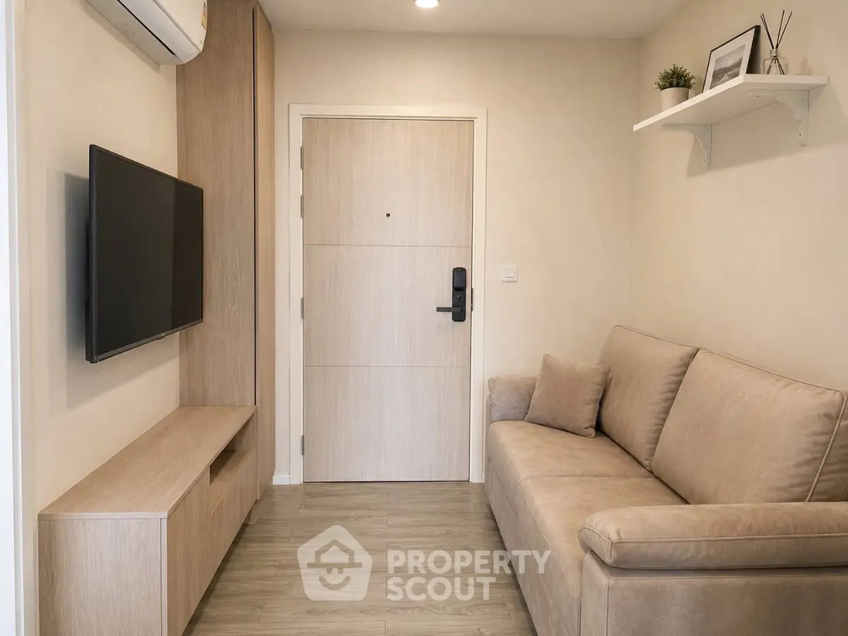Cozy living room with modern sofa and wall-mounted TV, perfect for relaxation.