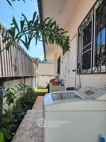 Charming outdoor laundry area with washing machine and garden view