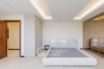 Spacious modern bedroom with sleek design and ample storage space