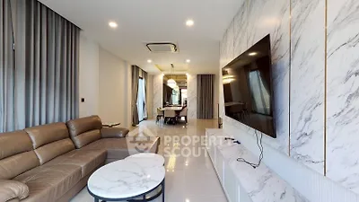 Luxurious modern living room with marble accents and spacious seating area