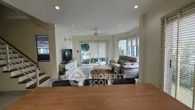 Spacious living room with modern decor and large windows offering natural light.