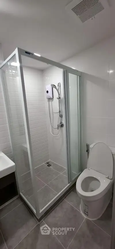 Modern bathroom with glass shower enclosure and sleek fixtures