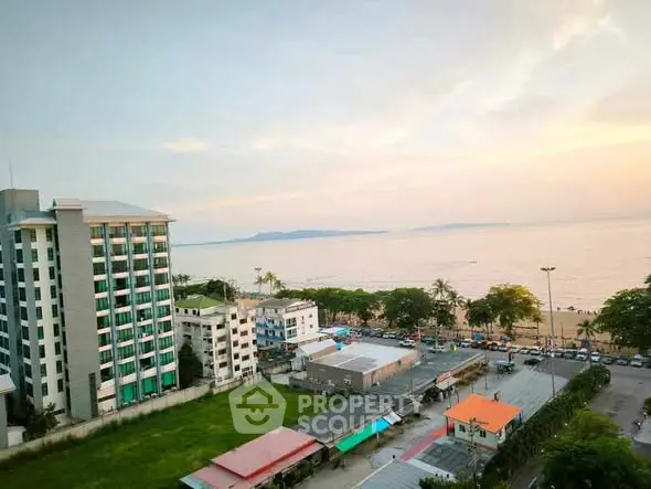 Stunning ocean view from high-rise building overlooking the beach and cityscape at sunset.