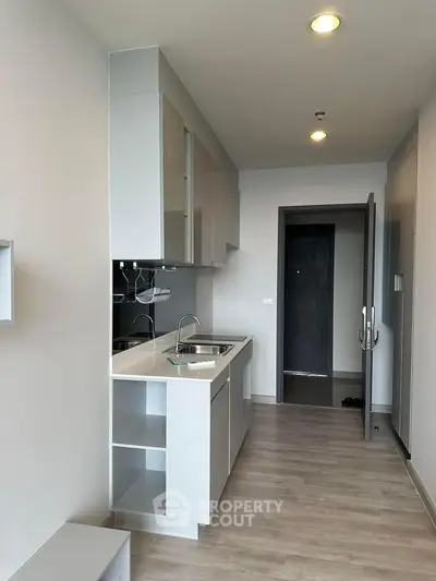 Modern kitchen with sleek cabinetry and open layout in contemporary apartment