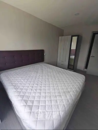 Spacious bedroom with modern design and ample natural light, featuring a comfortable bed and sleek wardrobe.