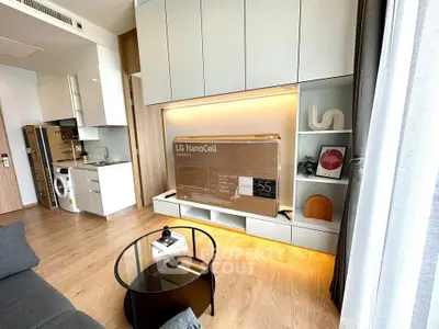 Modern living room with sleek cabinetry and new LG NanoCell TV, featuring stylish decor and natural light.