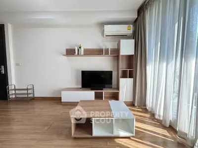 Modern living room with sleek furniture and large windows for natural light.