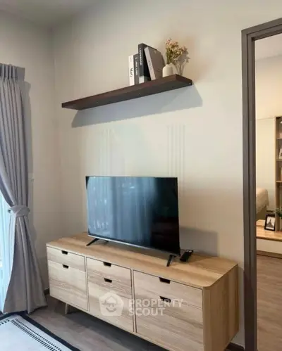 Modern living room with sleek TV stand and wall shelf, perfect for stylish urban living.