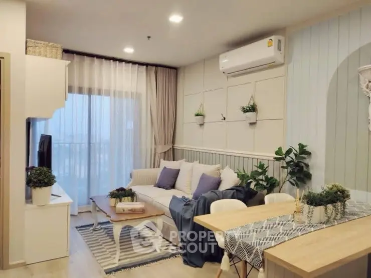 Charming living room with cozy decor and natural light, featuring a stylish sofa and dining area.