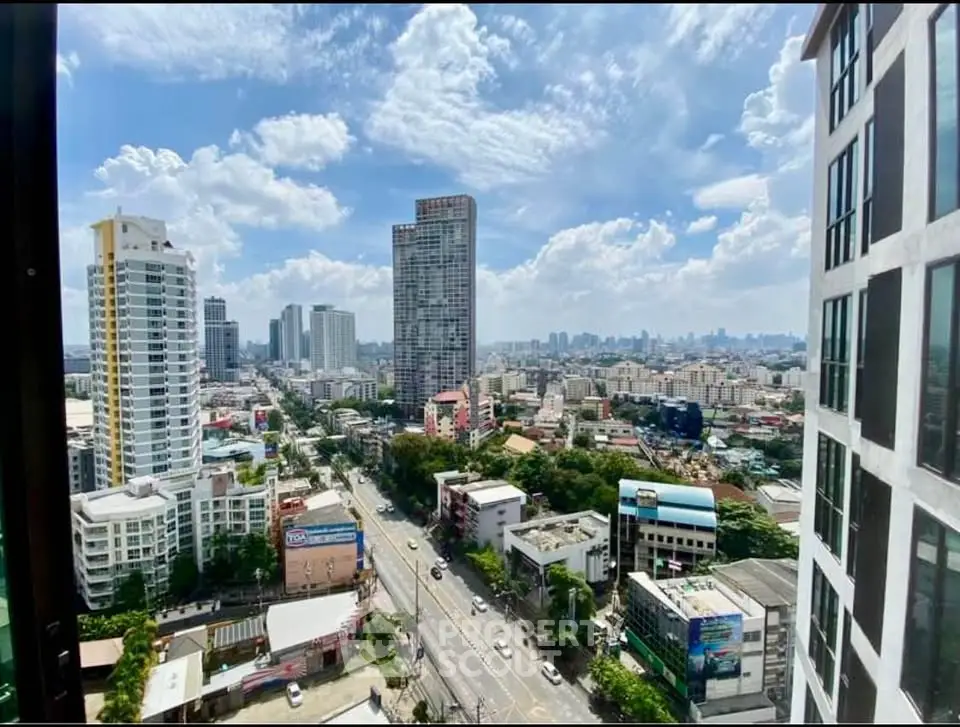 Stunning cityscape view from high-rise building with clear blue skies and urban skyline.