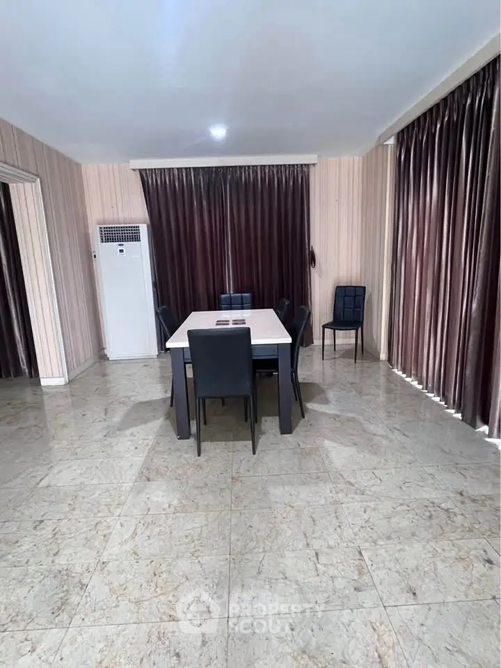 Spacious dining area with elegant marble flooring and modern furniture