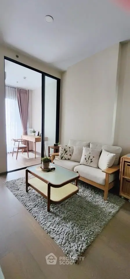 Charming living room with cozy seating and natural light, perfect for relaxation.