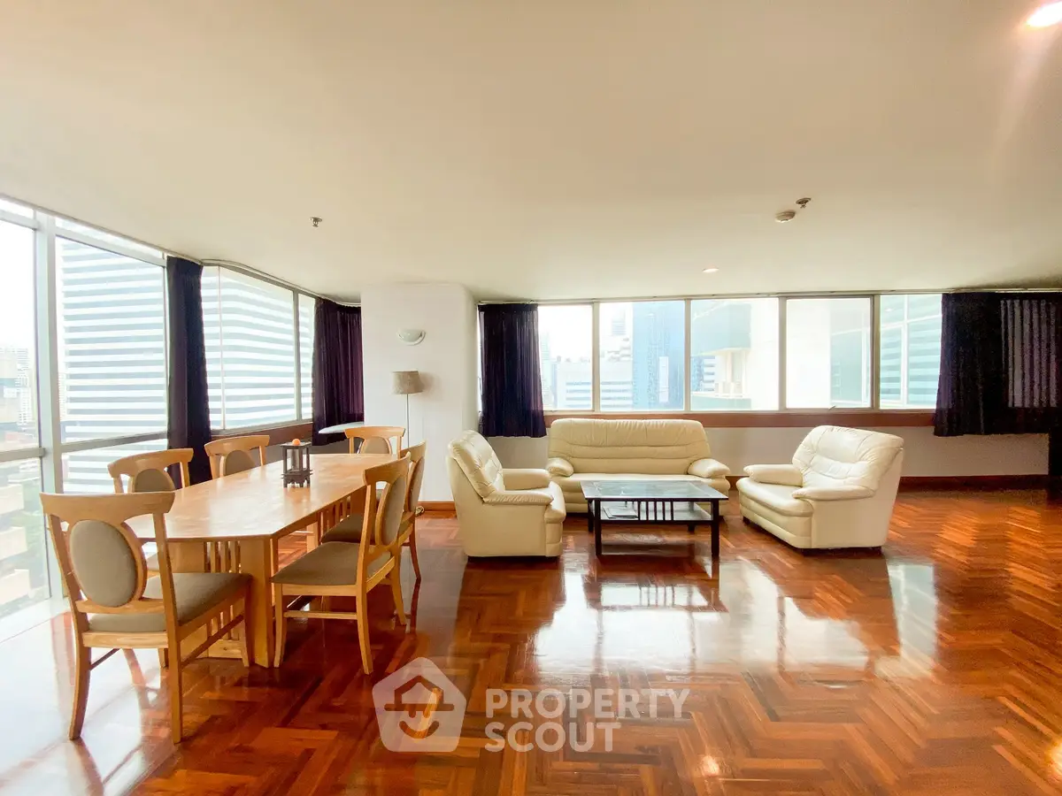 Spacious living room with elegant parquet flooring and city view