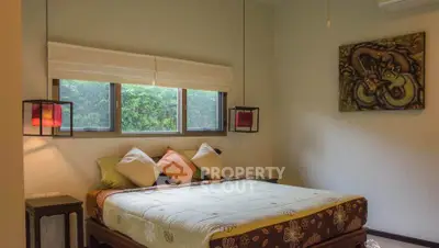Cozy bedroom with large window and stylish decor in a serene setting.