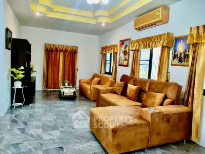 Spacious living room with plush brown sofas and elegant decor, perfect for relaxation and entertainment.