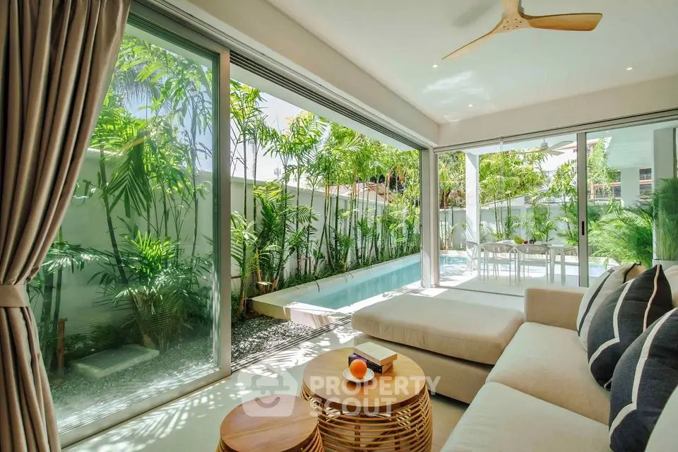 Luxurious living room with pool view and modern decor