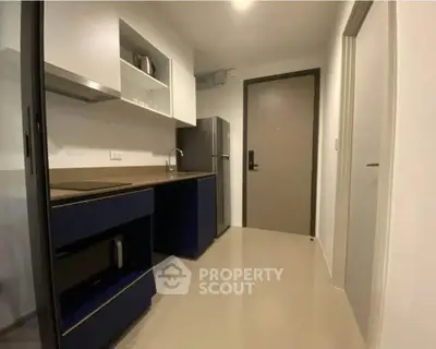 Modern compact kitchen with sleek cabinetry and stainless steel appliances